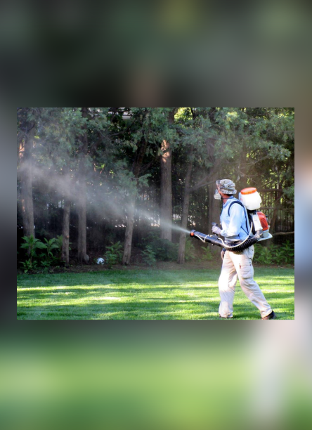 A man spraying water from the back of his backpack.